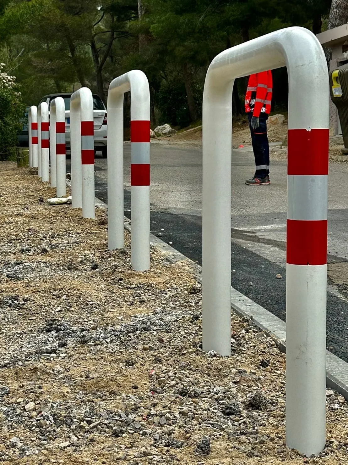Potelets rouges et blancs protégeant un cheminement piéton