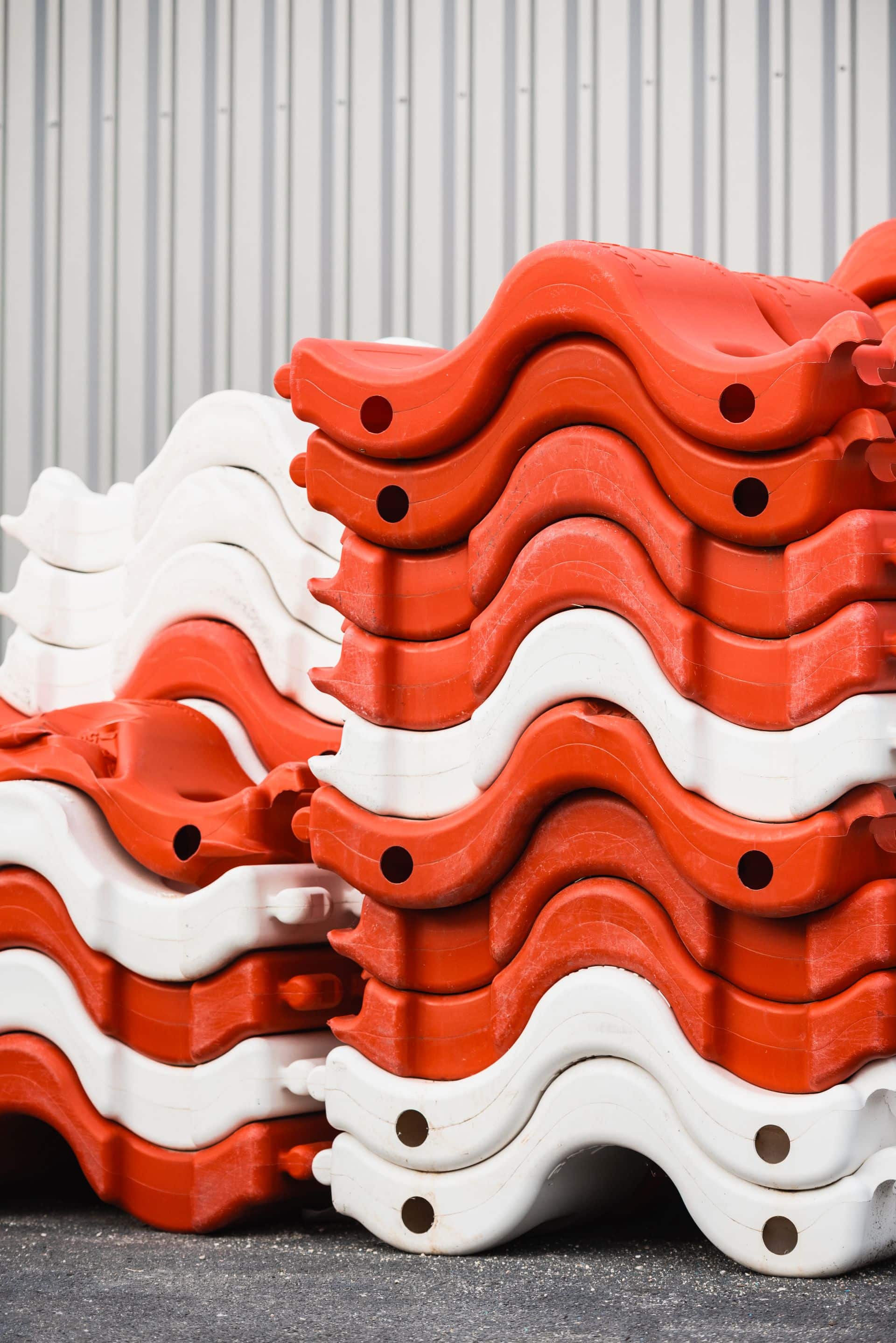 Barrières de chantier rouges et blanches empilées dans le stock ASM